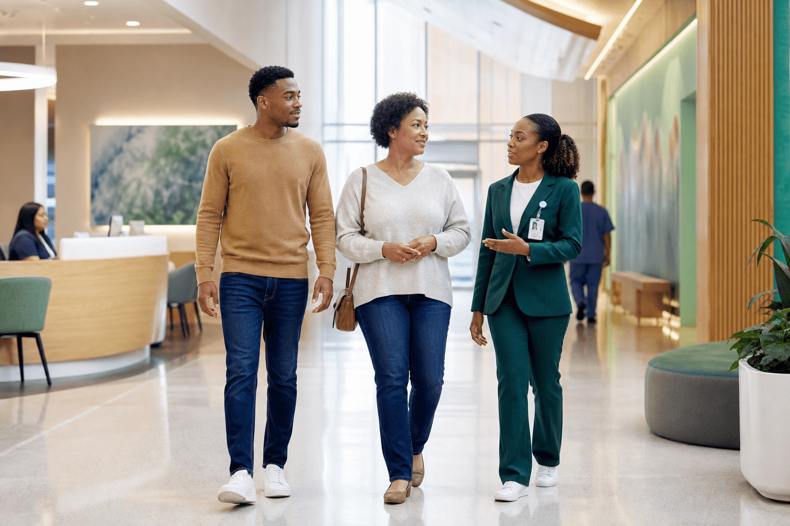 A patient and family member being guided through a hospital by a care coordinator